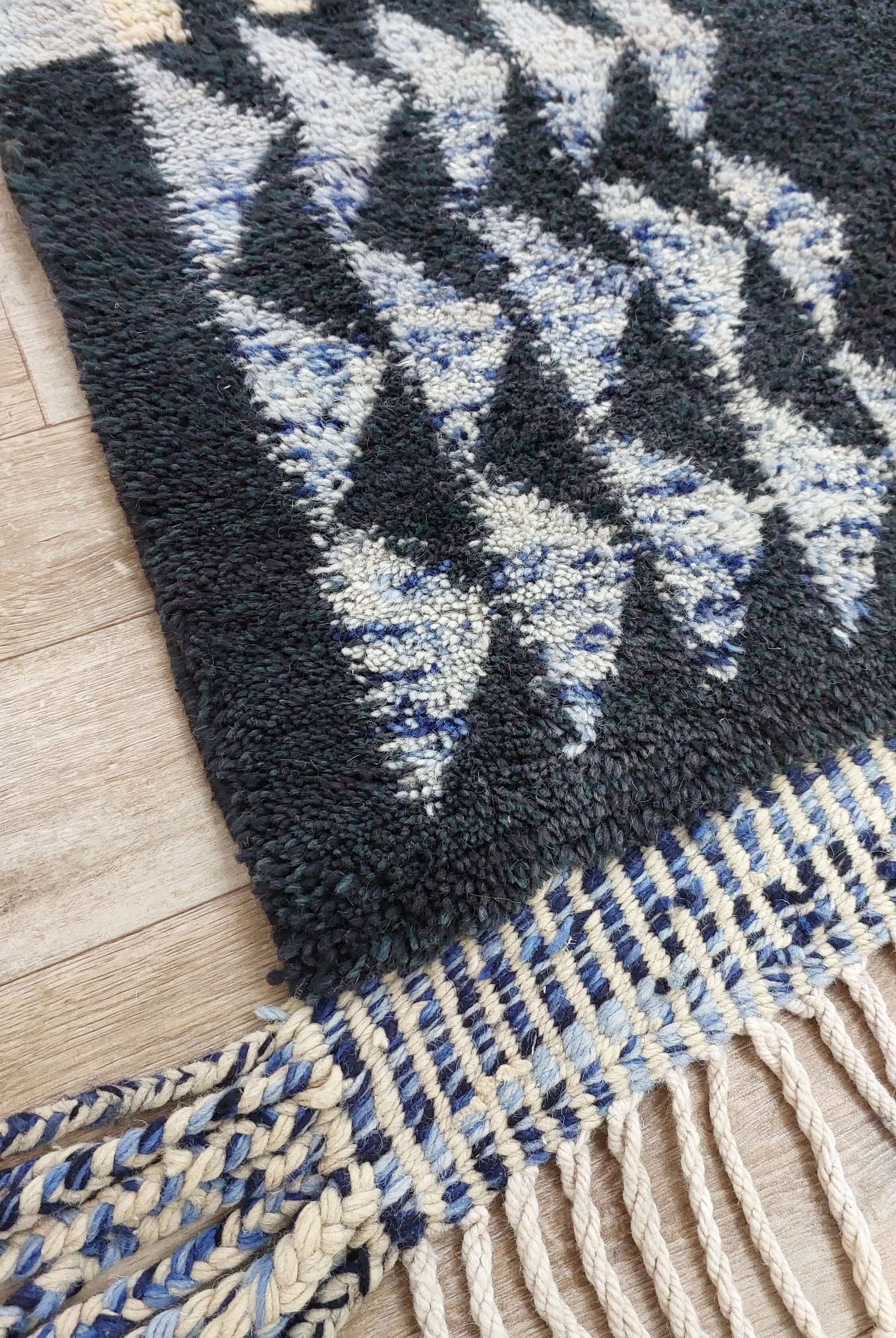 Blue and black Moroccan rug with fringe detailing