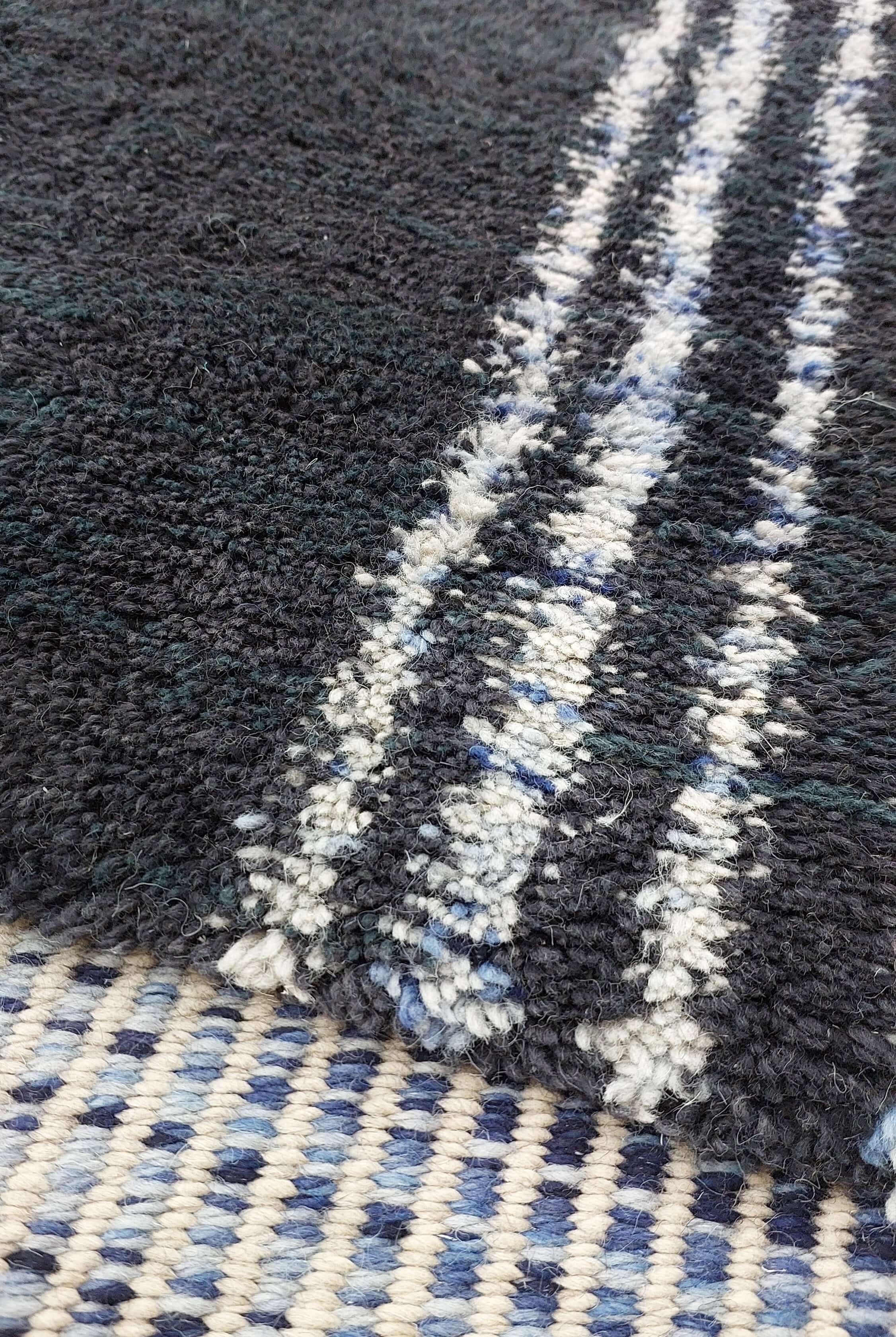Detailed image of a blue and black striped Moroccan rug