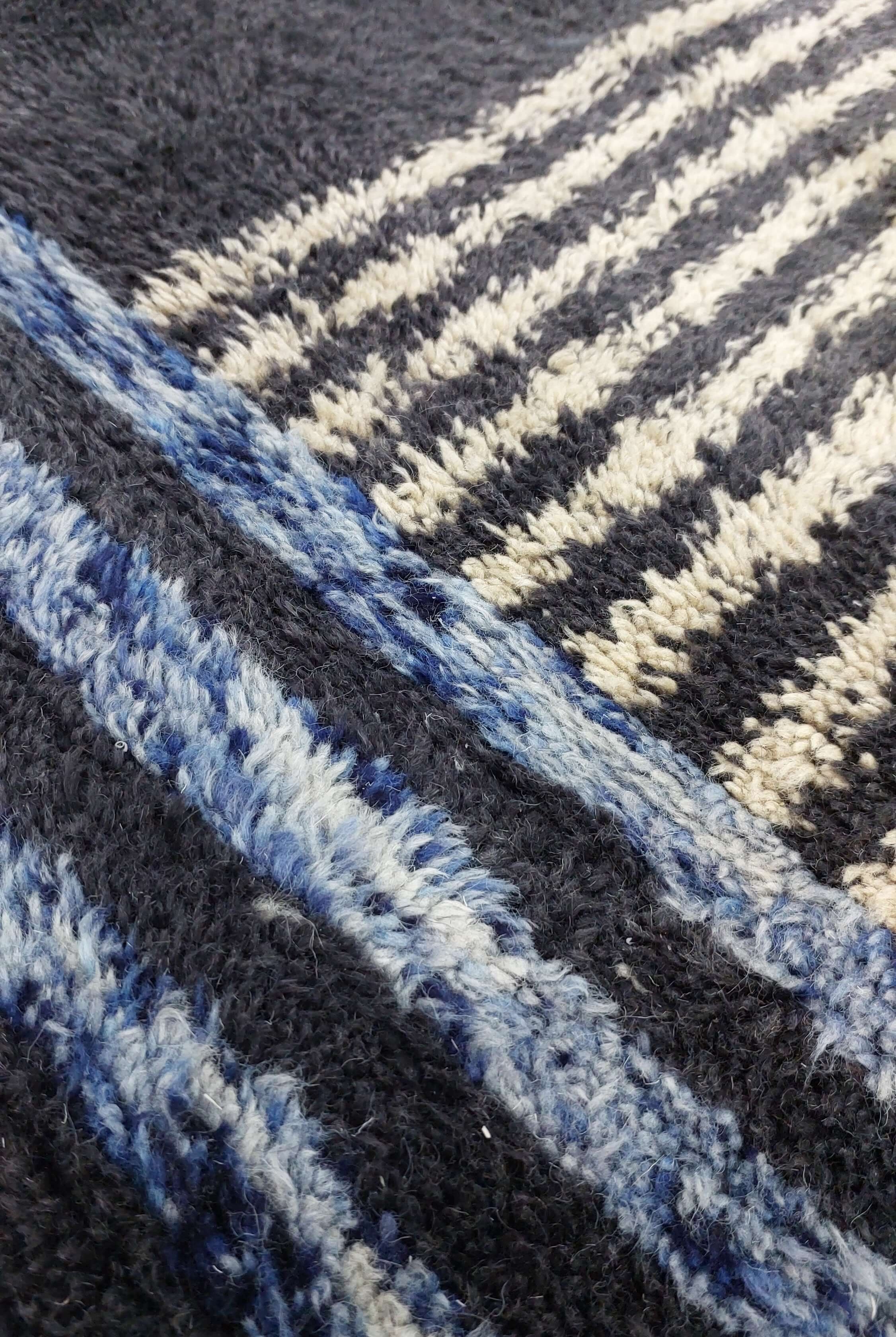 Detailed view of a Moroccan rug in blue and black