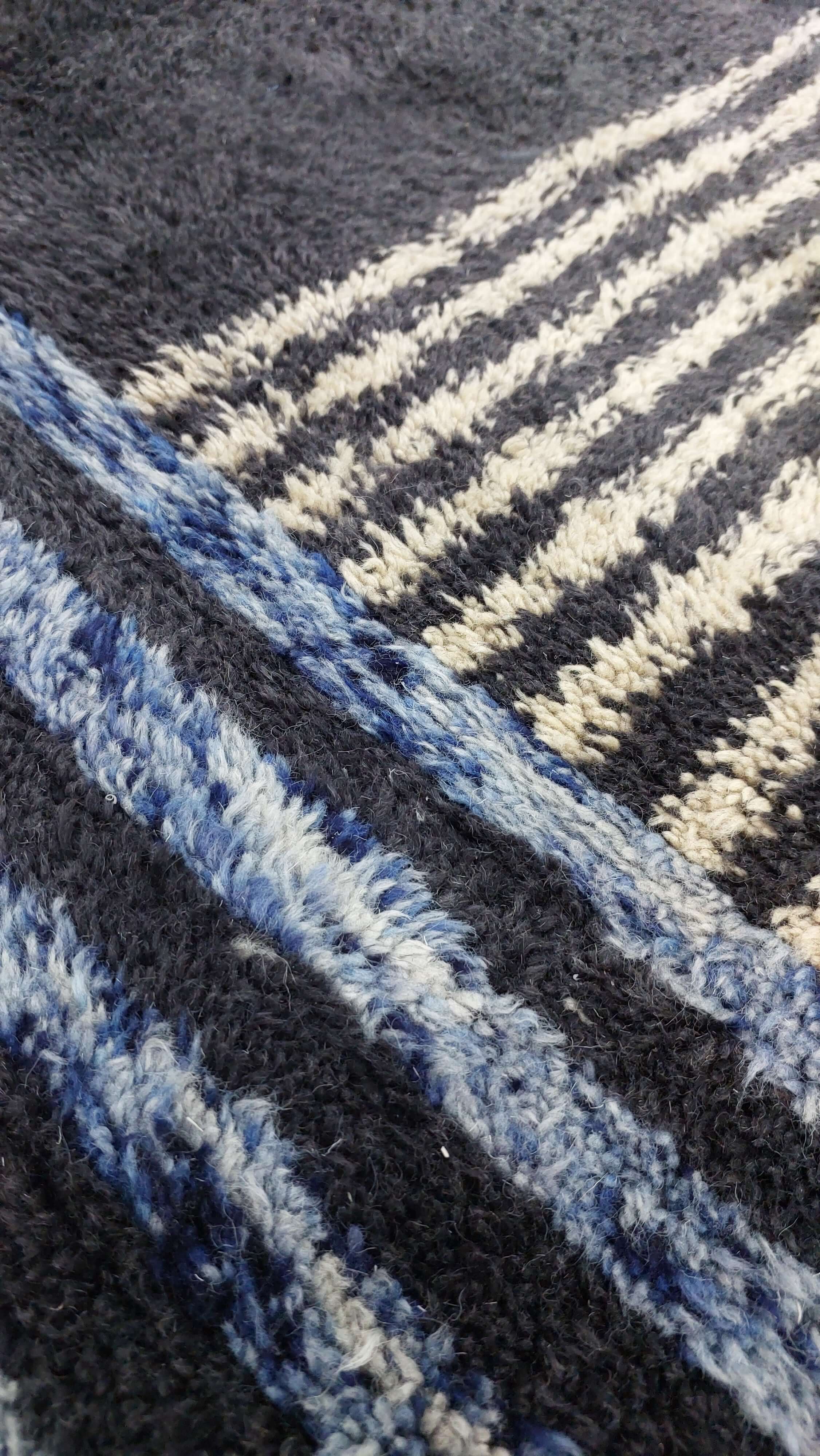 Detailed view of a Moroccan rug in blue and black