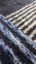 Load image into Gallery viewer, Detailed view of a Moroccan rug in blue and black