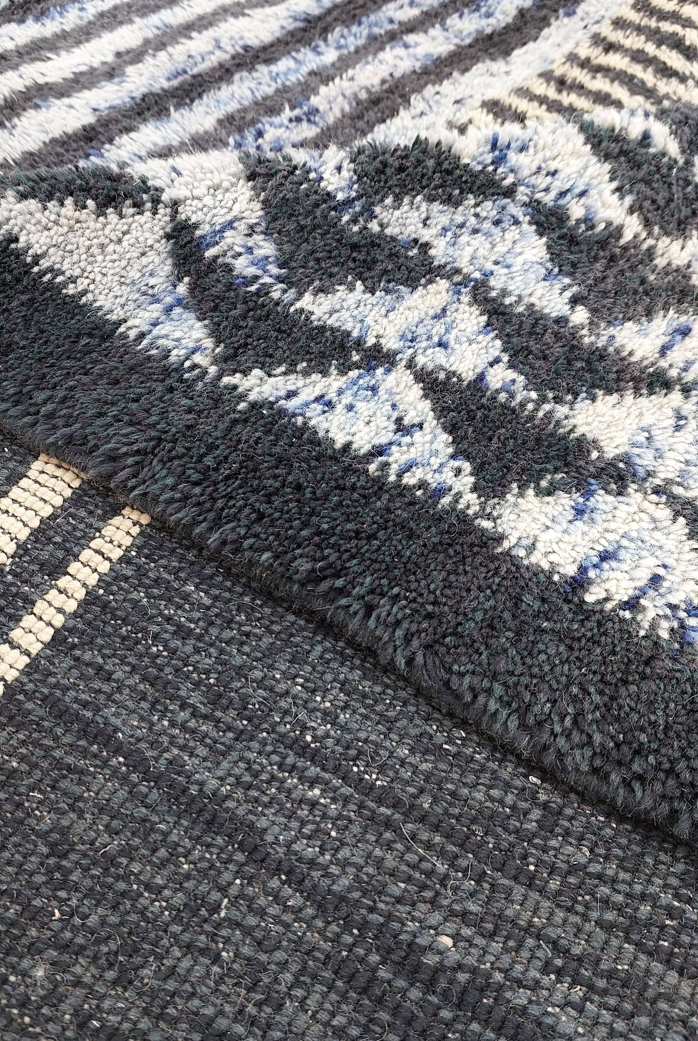 Macro shot of a blue and black striped Moroccan rug