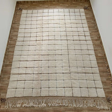 Load image into Gallery viewer, White custom Moroccan rug positioned on a wooden floor