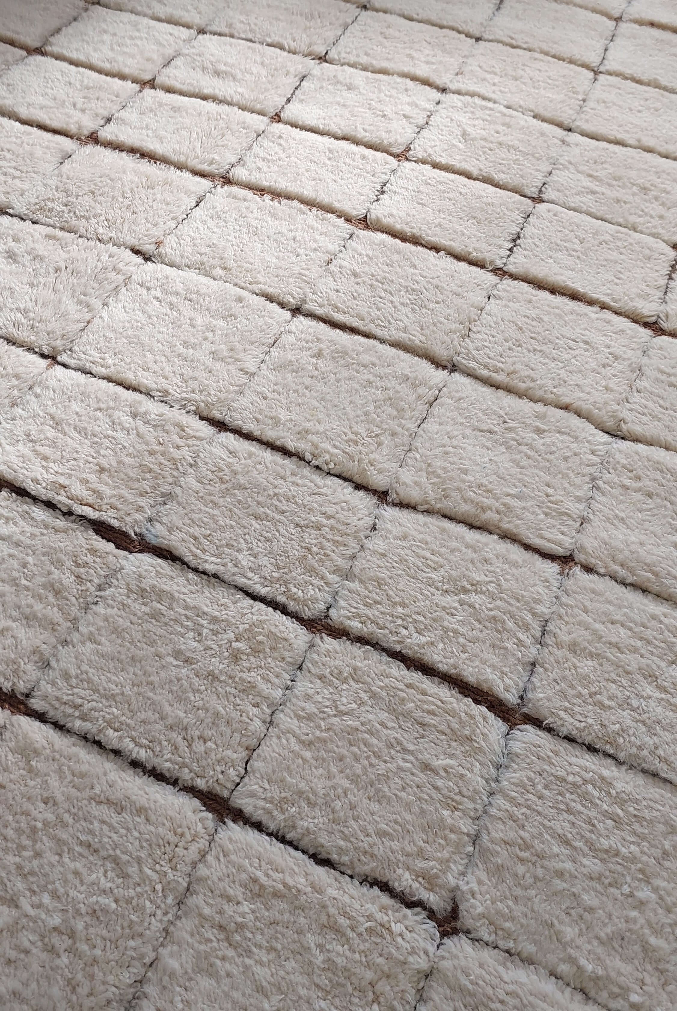 Macro shot of a custom Moroccan rug featuring square designs