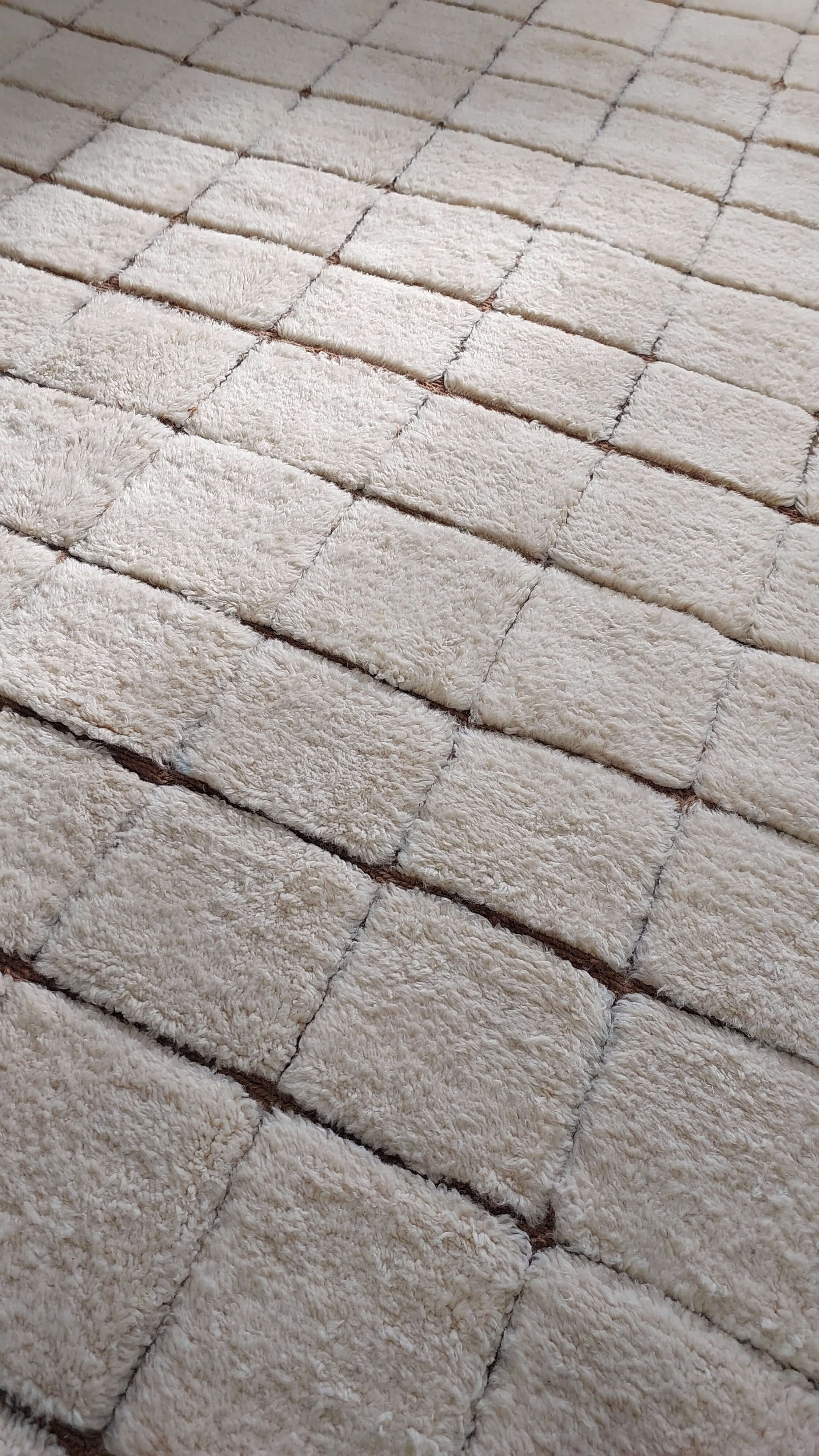 Macro shot of a custom Moroccan rug featuring square designs