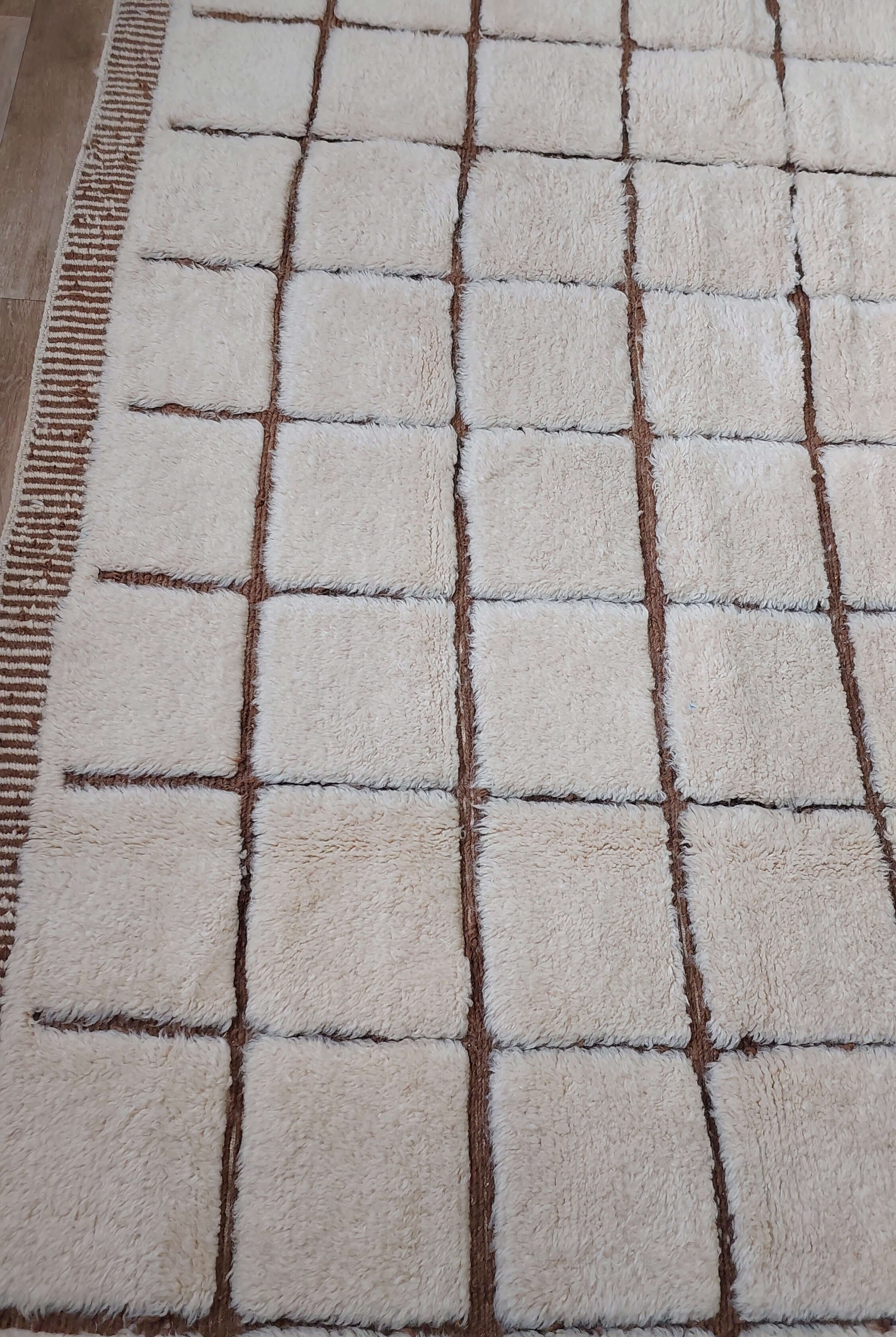 Custom Moroccan rug with square patterns displayed in a room setting