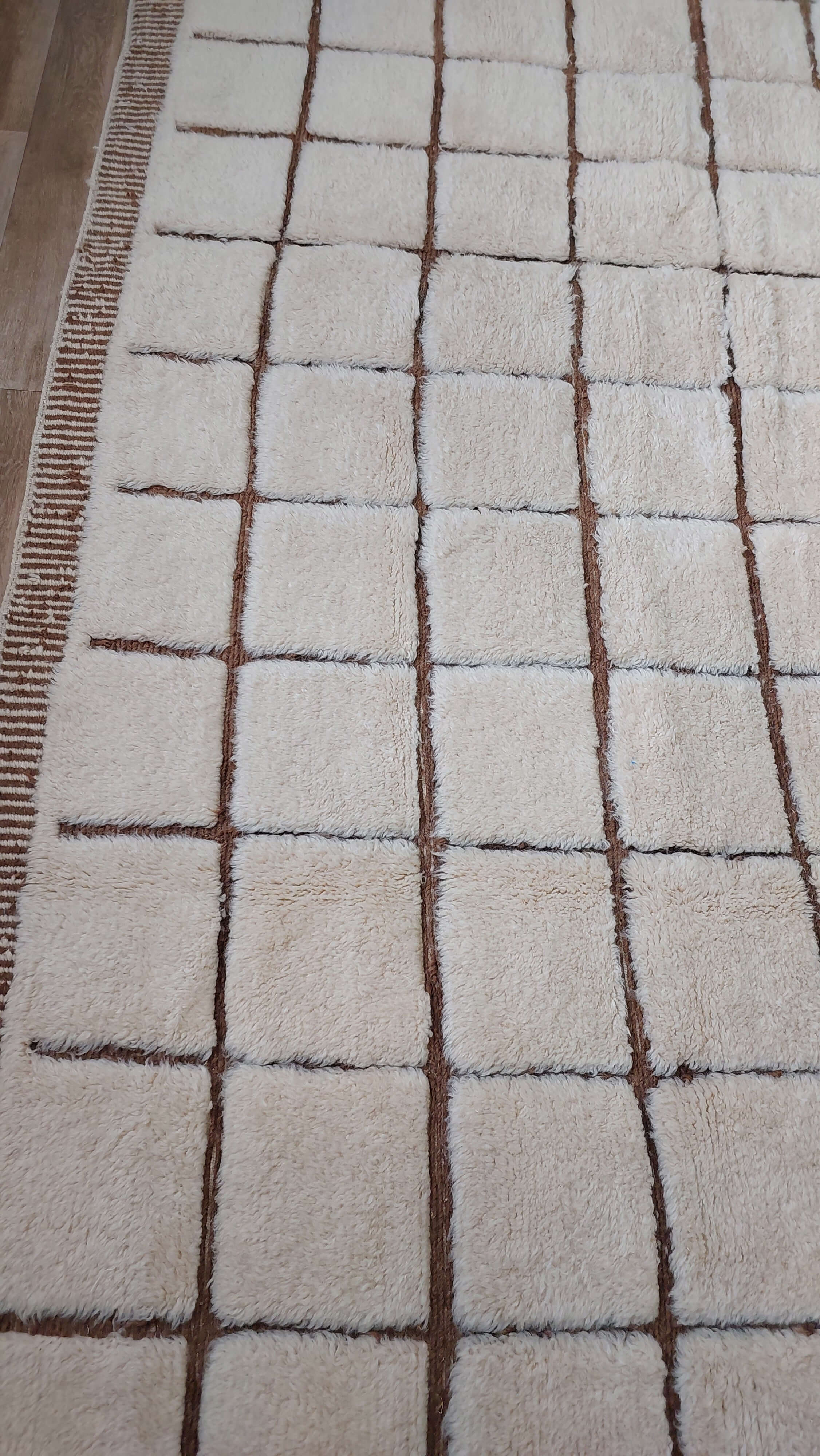 Custom Moroccan rug with square patterns displayed in a room setting