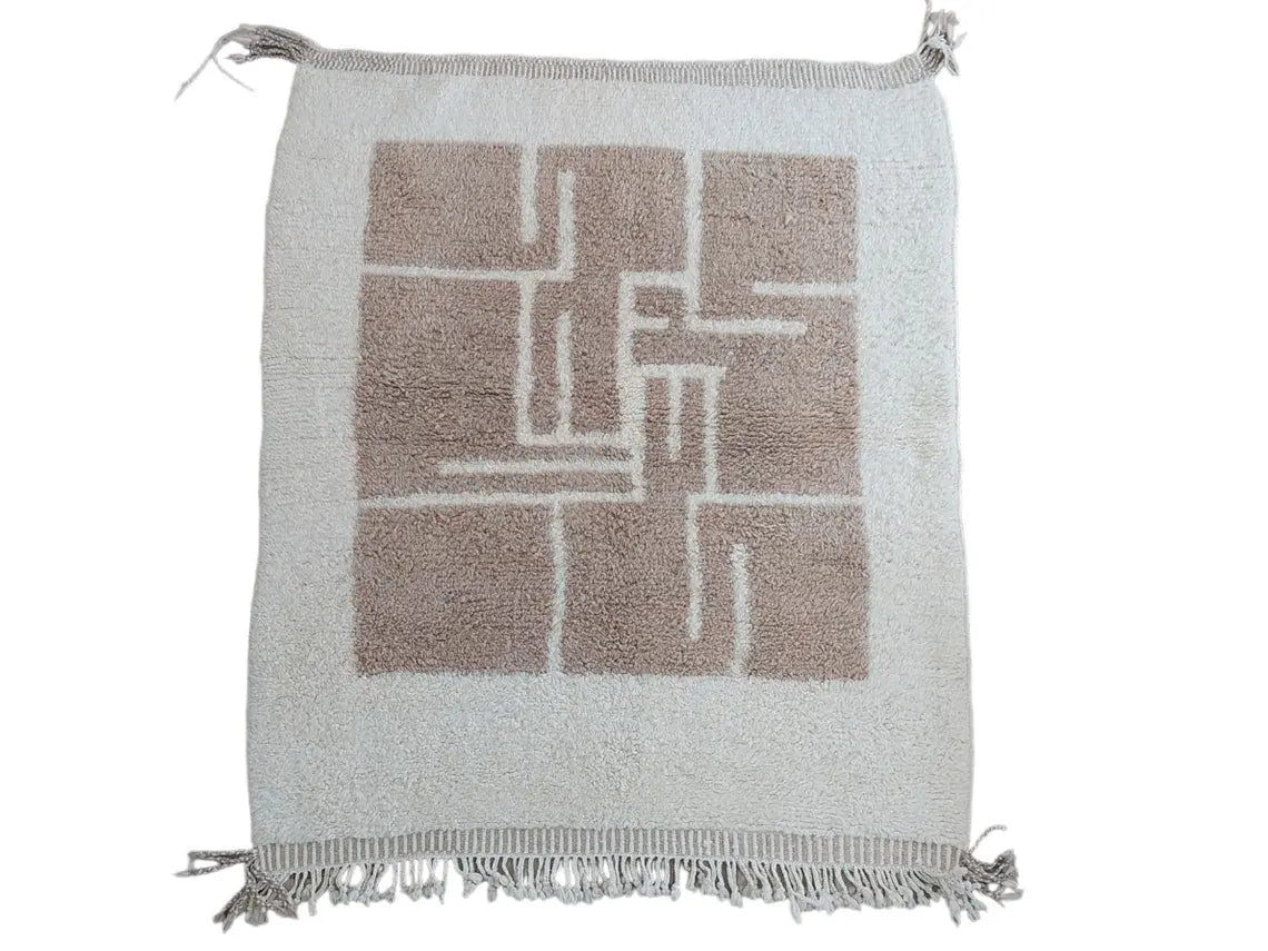 Moroccan rug with geometric pattern and fringe on a white background
