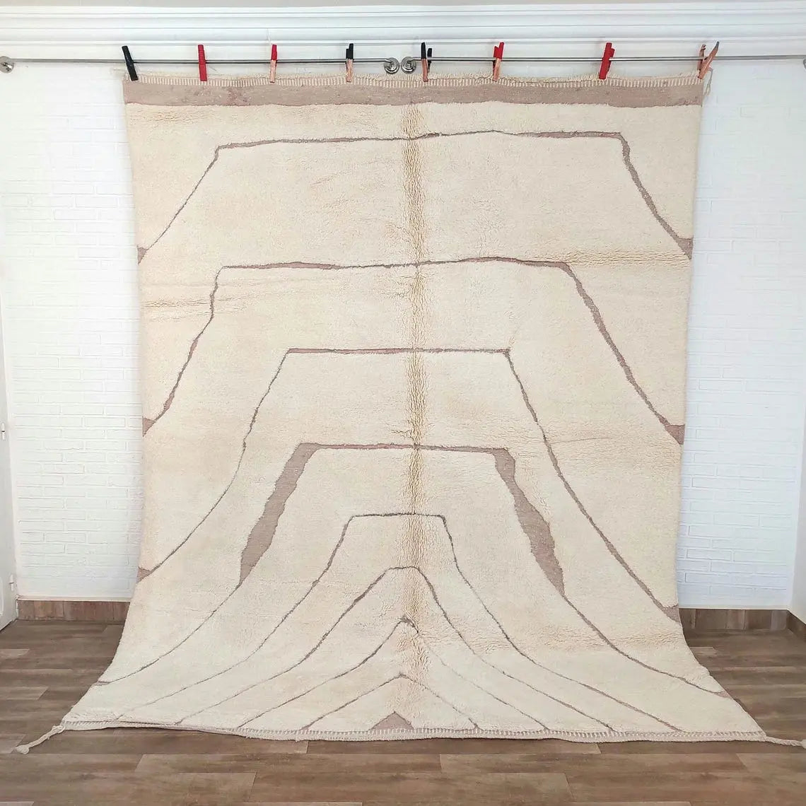 Moroccan Beni mrirt rug art piece with abstract design on a wooden floor