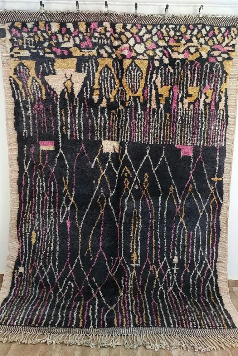 Moroccan rug , beni mrirt style with geometric pattern on a wooden floor