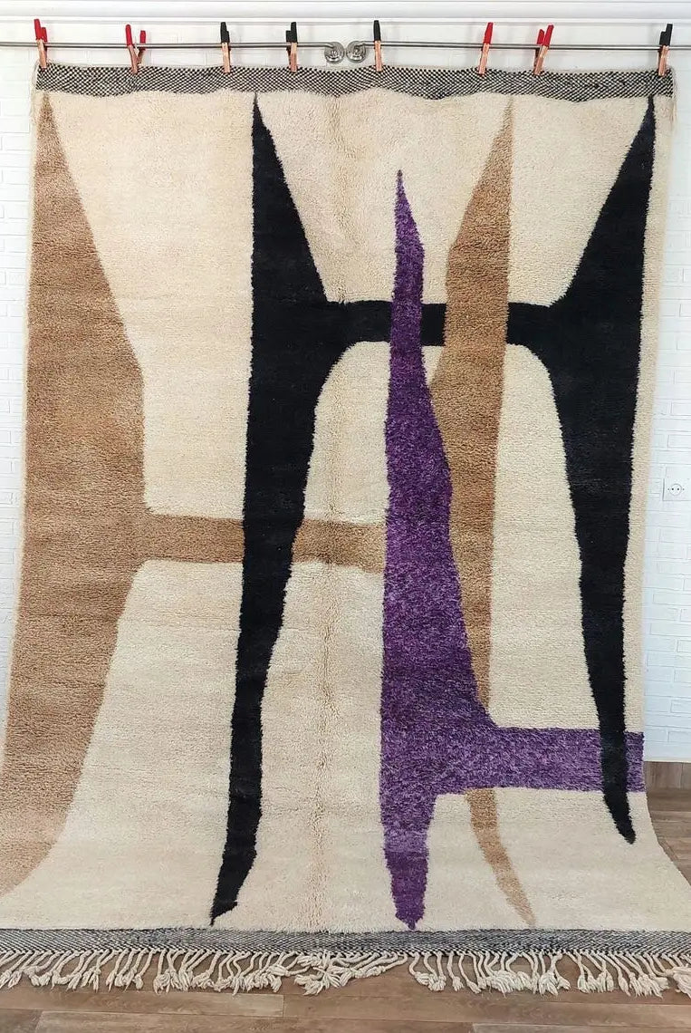 Moroccan beni mrirt rug art piece with geometric design on a wooden floor.