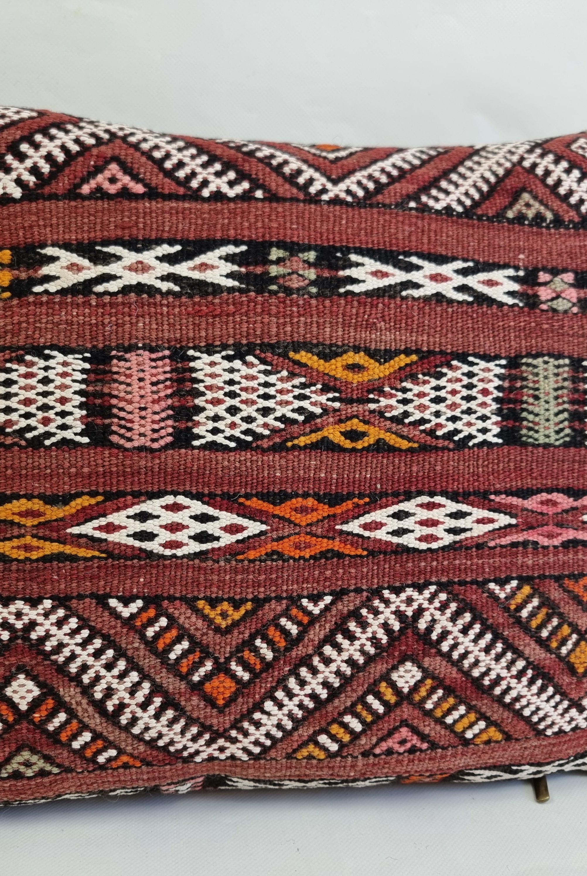 Decorative pillow with intricate geometric pattern on a white background