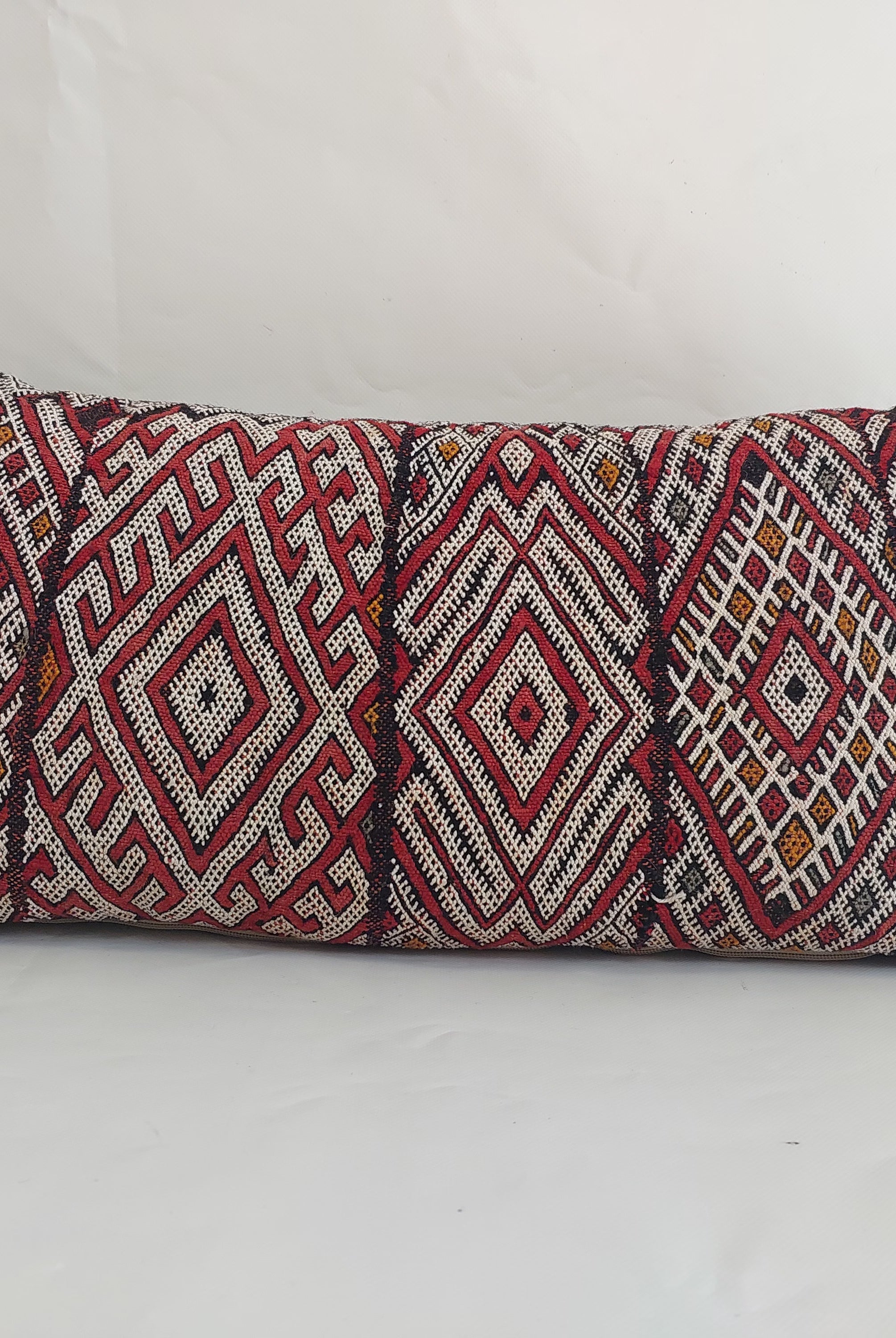 Decorative pillow with geometric pattern on a white background