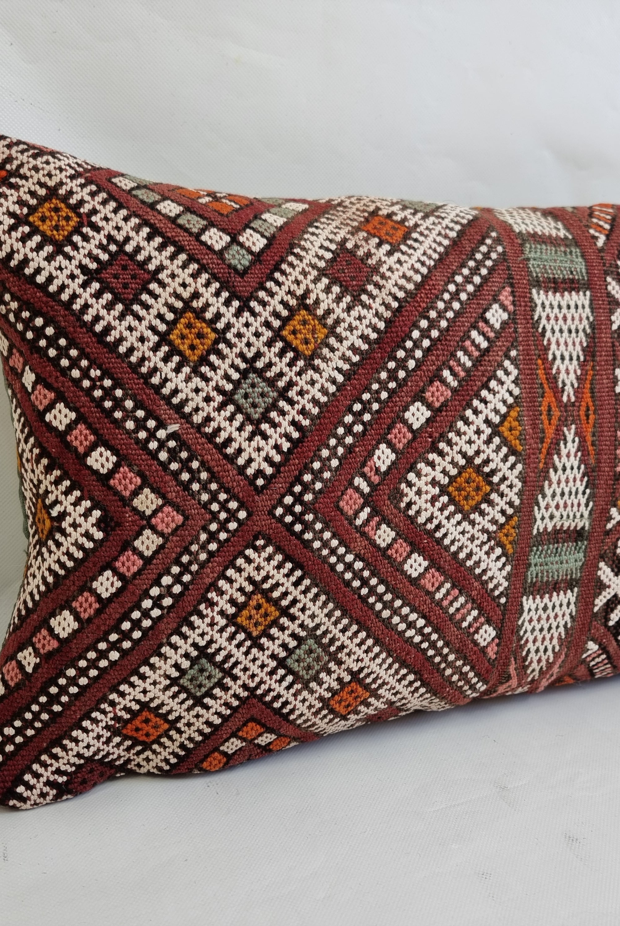 Decorative pillow with geometric pattern on a white background
