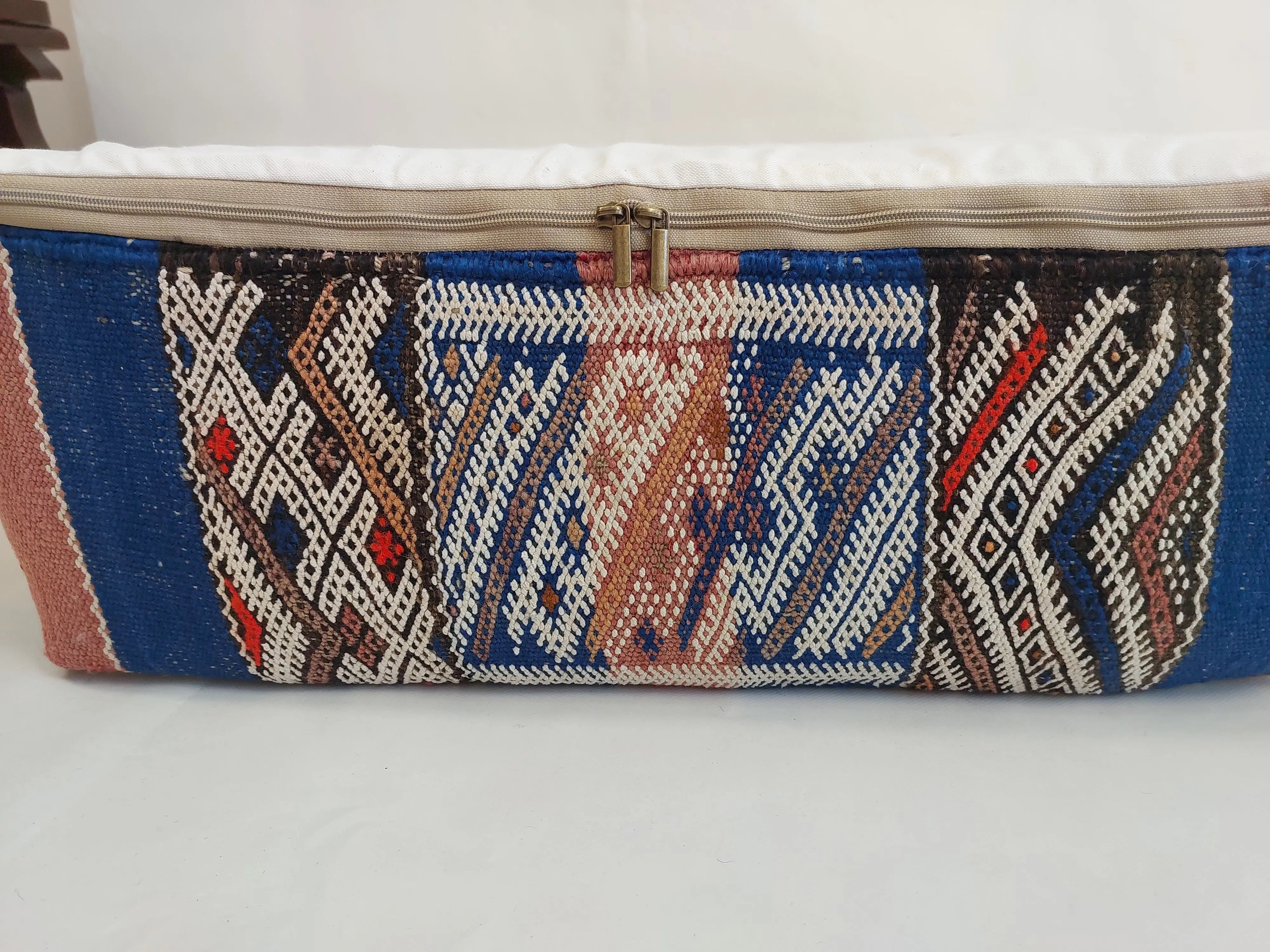 Textile blue pouf with geometric pattern on a white background
