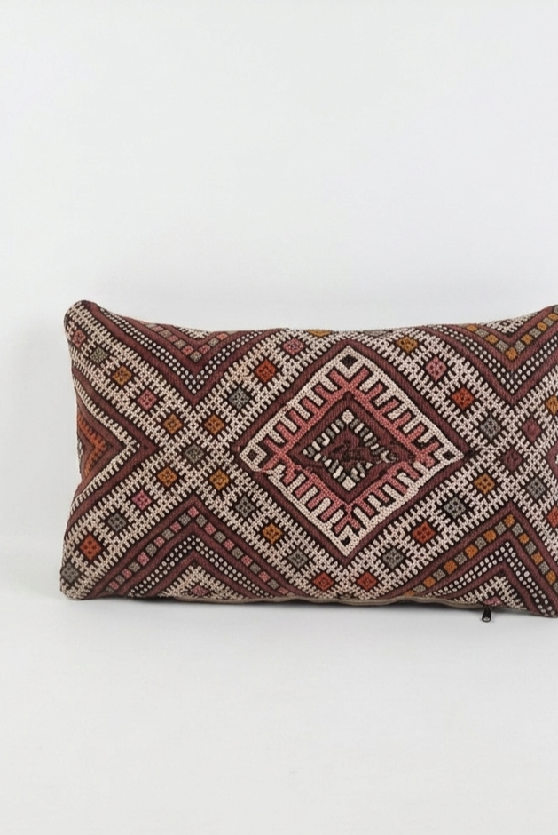 Decorative pillow with geometric pattern on a white background