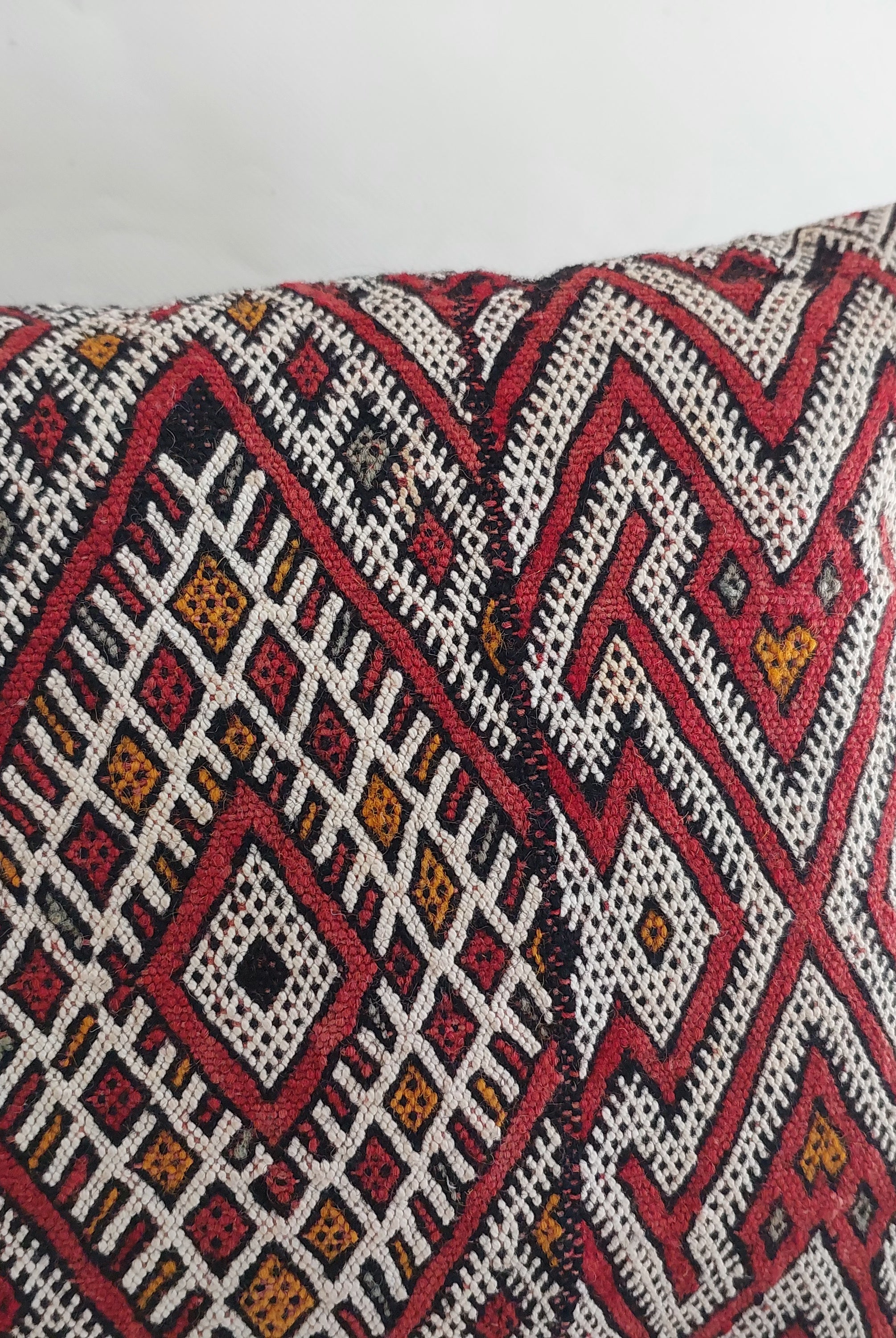 Decorative pillow with geometric pattern on a white background