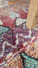 Load image into Gallery viewer, Masterpiece Moroccan rug placed under a wooden table and chair