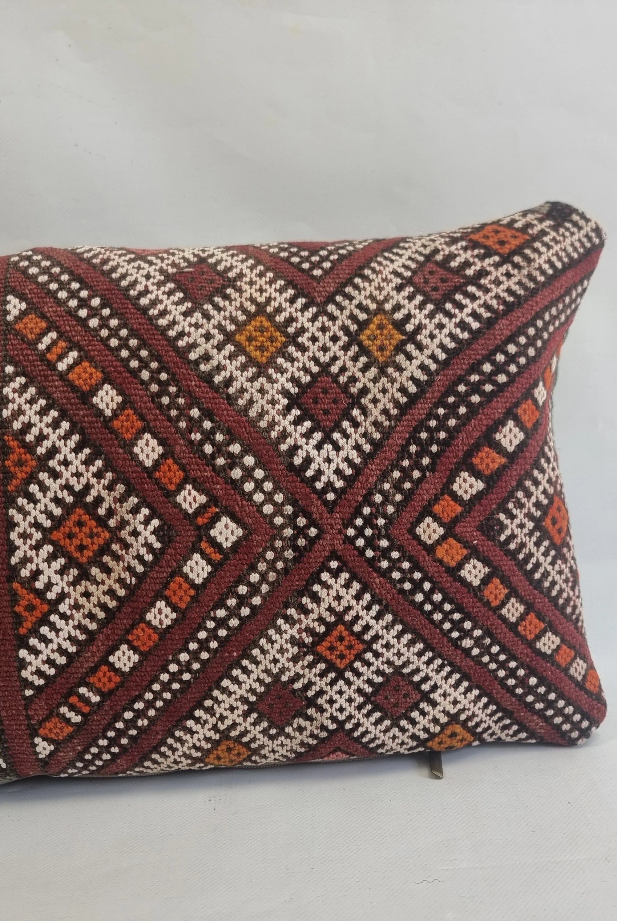 Decorative pillow with geometric pattern on a white background