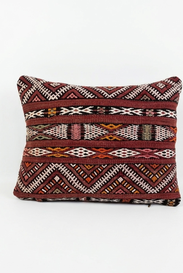 Decorative pillow with tribal pattern on a white background