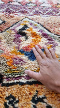 Load image into Gallery viewer, Close-up view of a hand touching the texture of the Masterpiece Moroccan rug