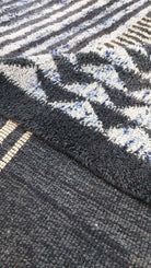 Macro shot of a blue and black striped Moroccan rug
