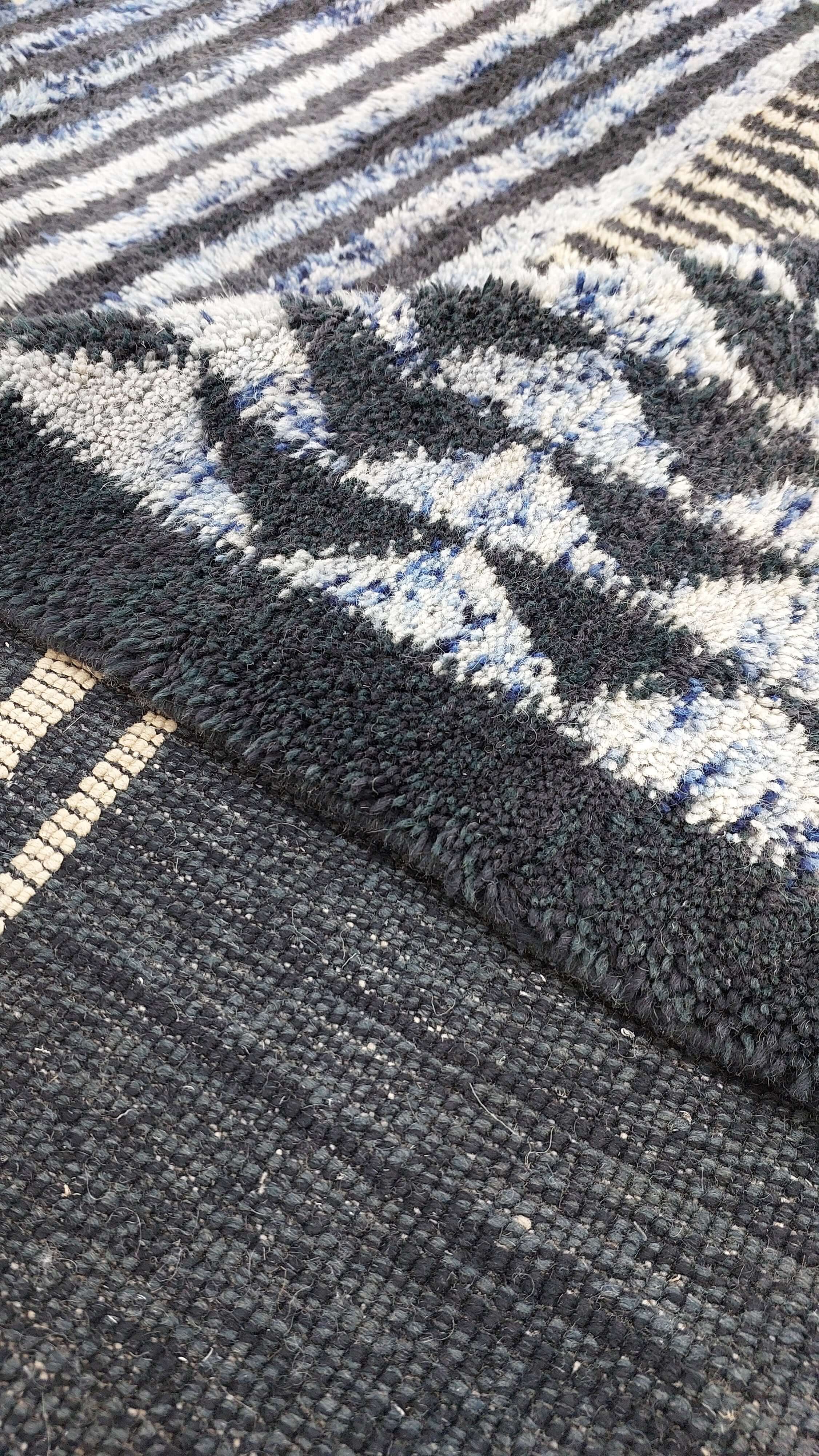 Macro shot of a blue and black striped Moroccan rug