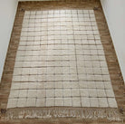 White custom Moroccan rug positioned on a wooden floor
