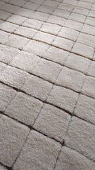 Macro shot of a custom Moroccan rug featuring square designs