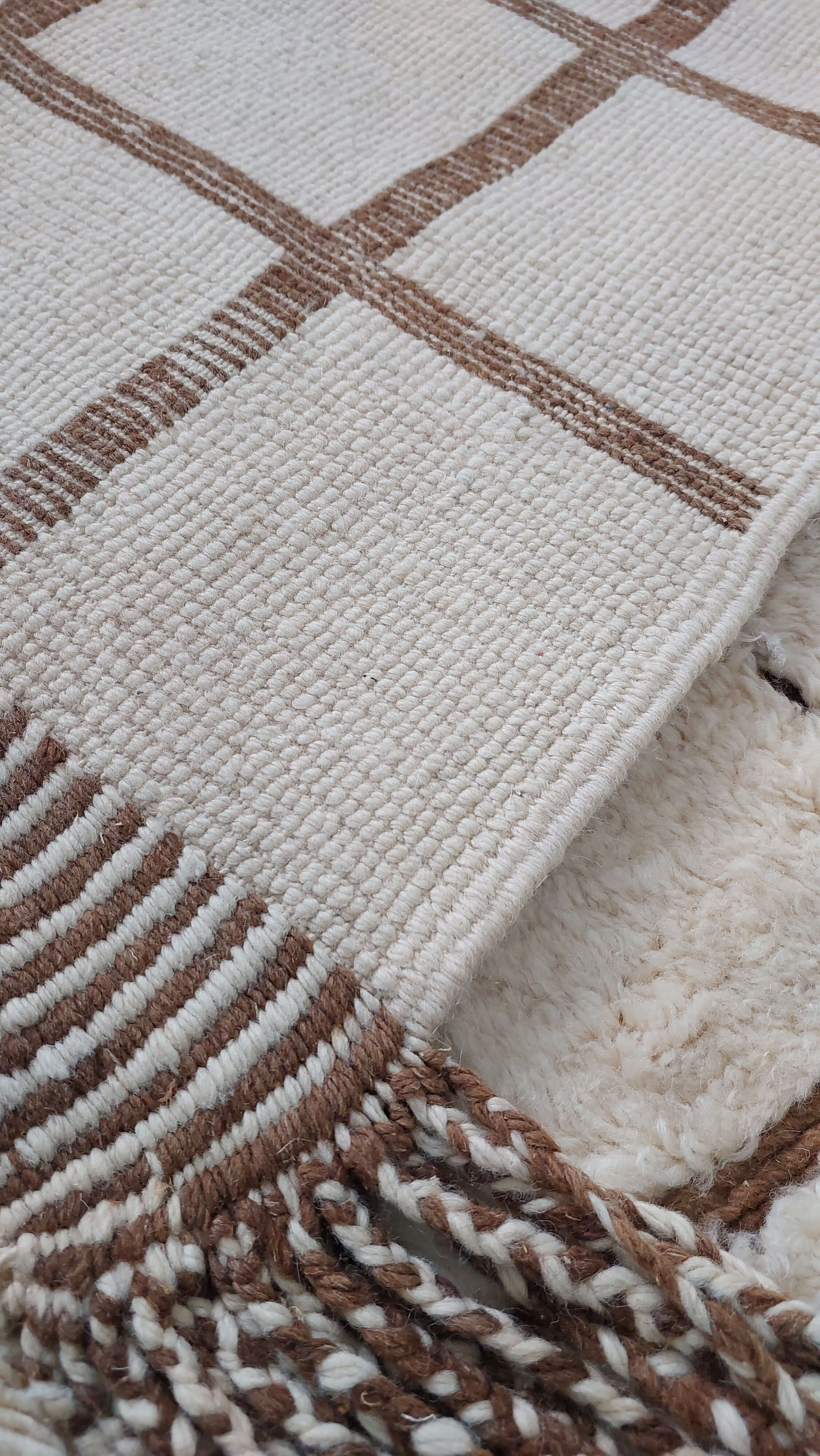 Close-up image of a custom Moroccan rug highlighting its tassel