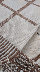 Close-up image of a custom Moroccan rug highlighting its tassel