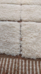 Custom Moroccan rug displaying white and brown stripes