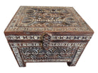 Decorative wooden box with intricate carvings on a white background