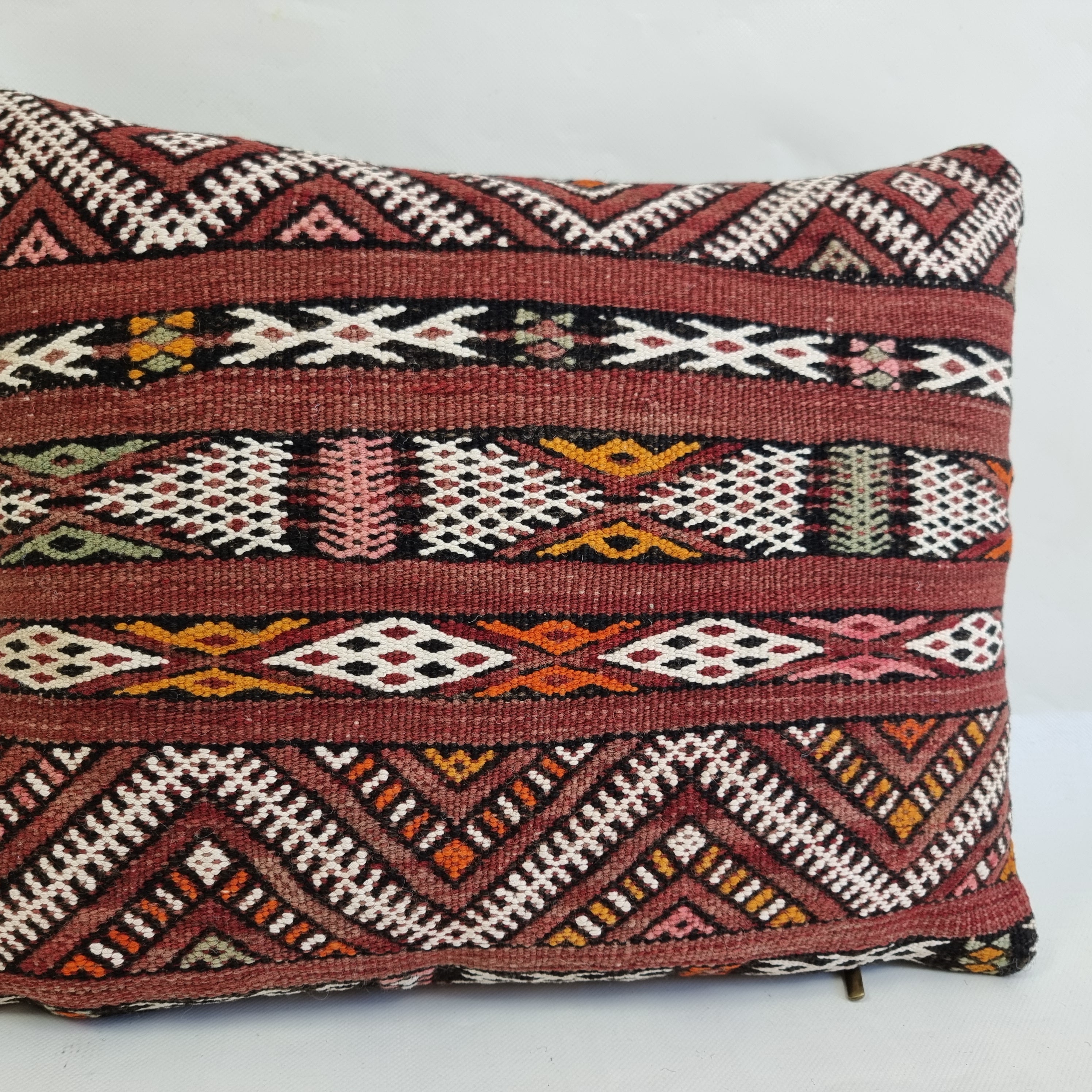 Decorative pillow with intricate geometric pattern on a white background