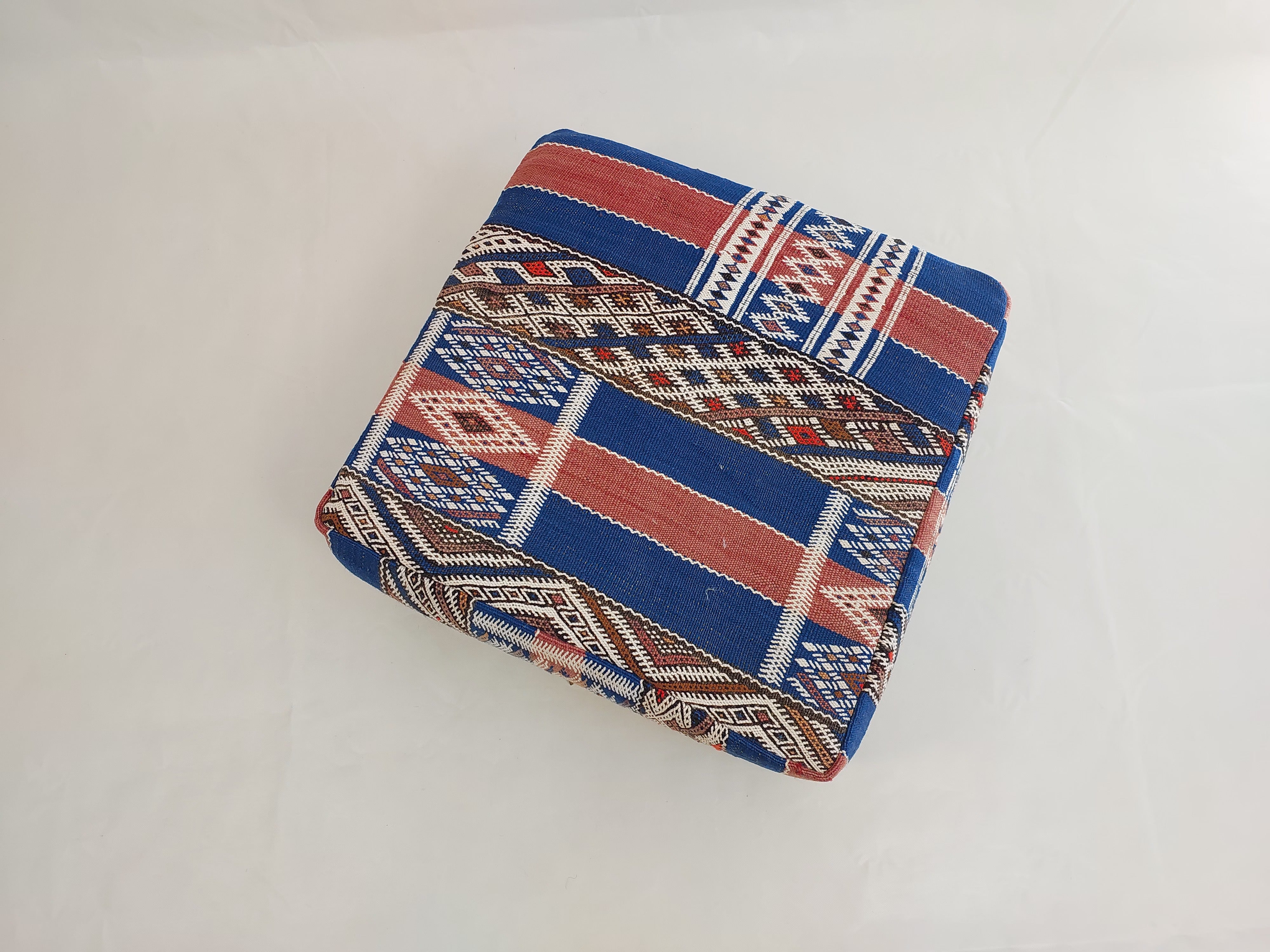 Folded fabric with a geometric pattern on a white background