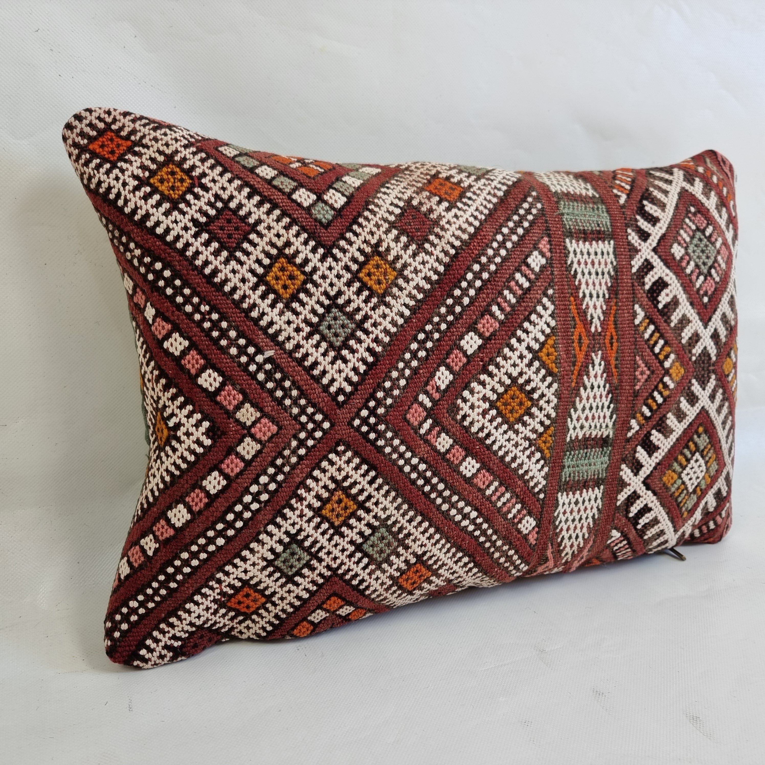 Decorative pillow with geometric pattern on a white background
