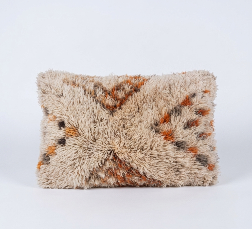 Fluffy beni ourain pillow with brown and beige pattern on a white background
