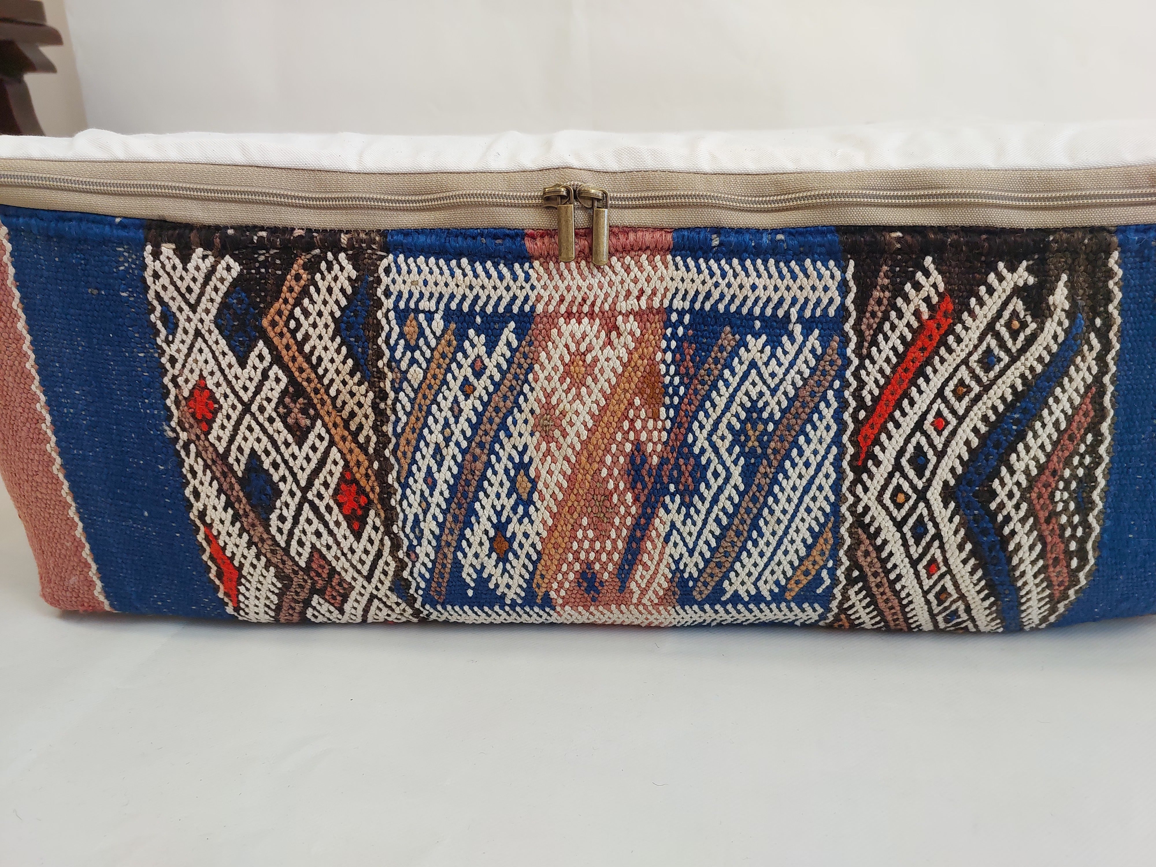 Textile blue pouf with geometric pattern on a white background