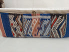 Textile blue pouf with geometric pattern on a white background