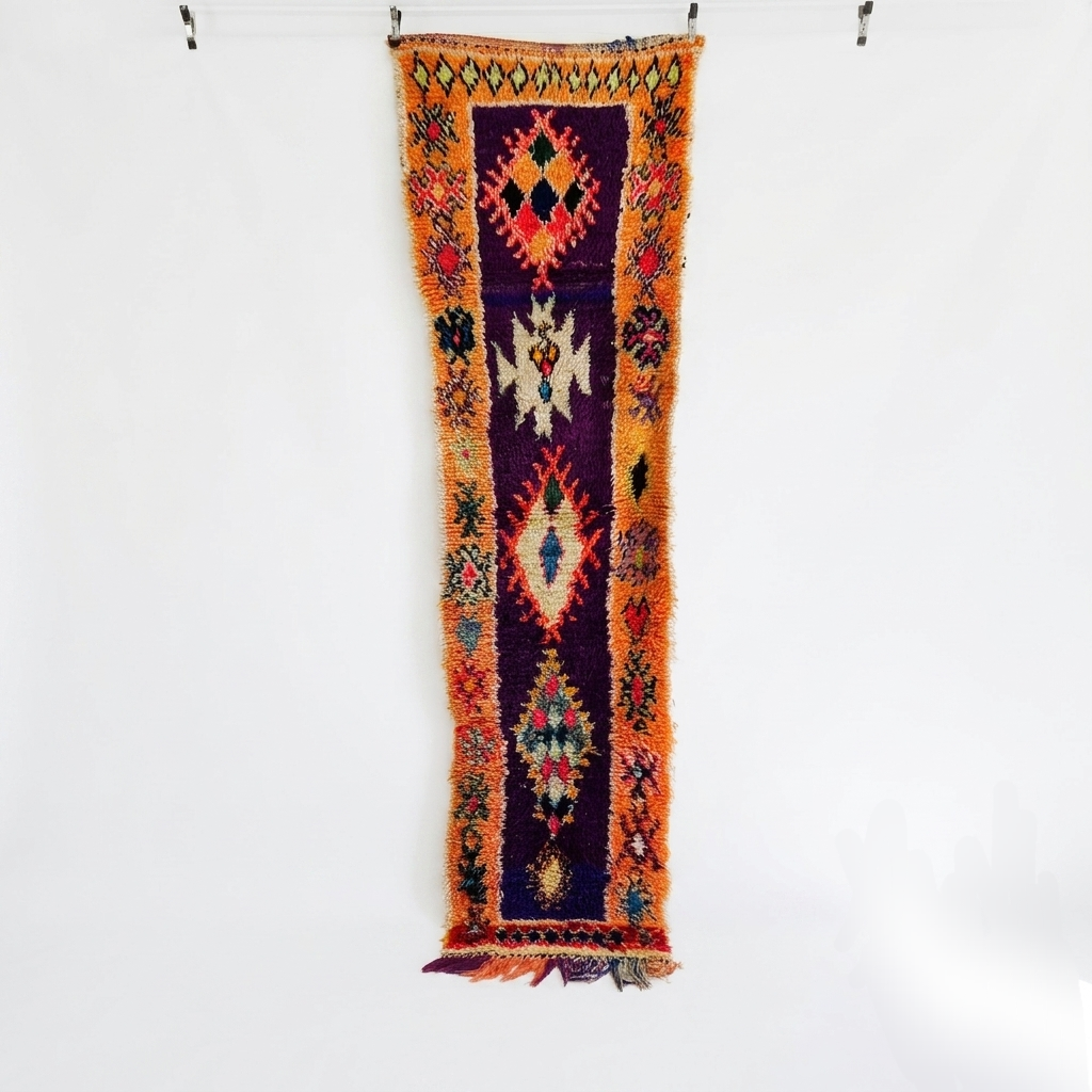 Colorful patterned rug hanging on a white wall