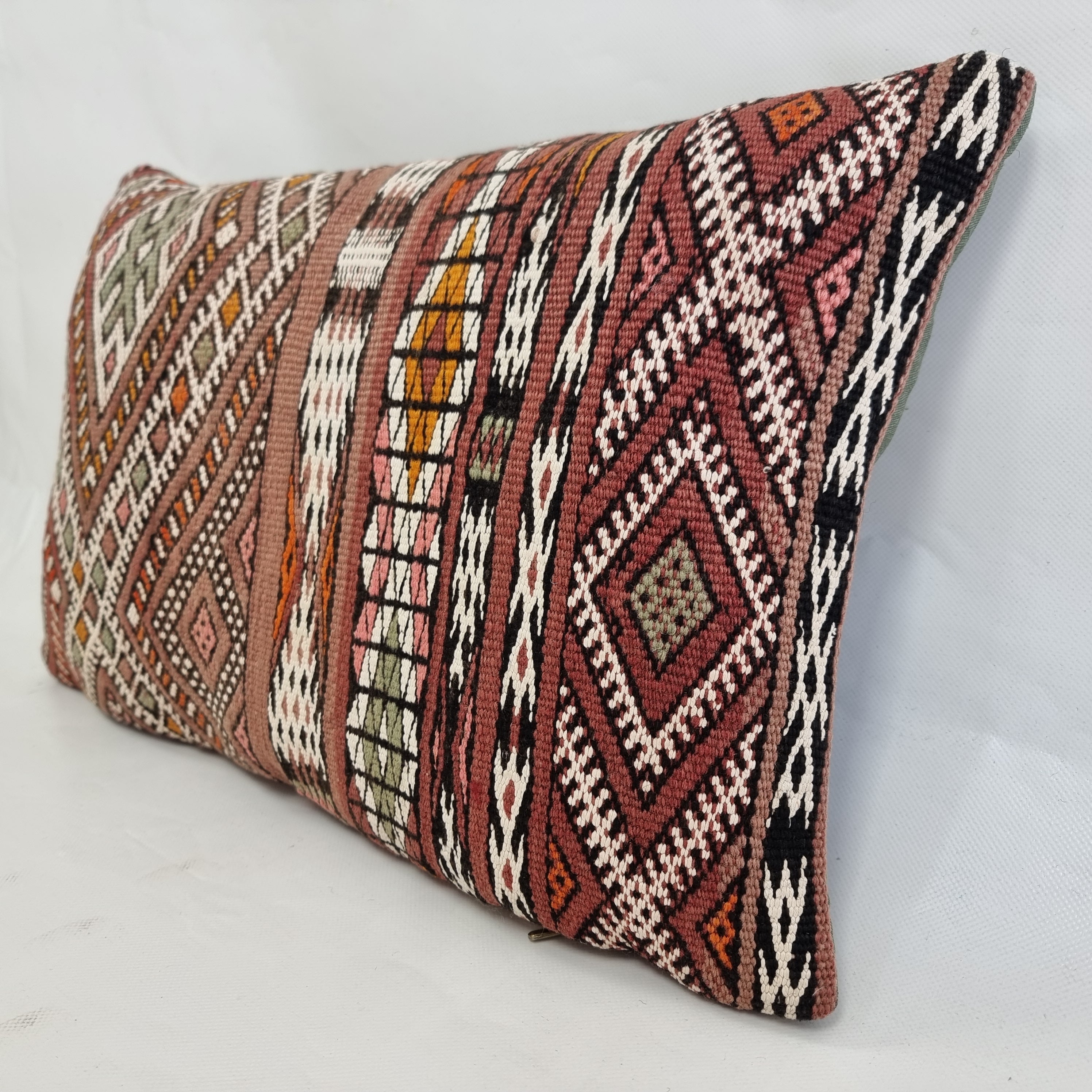 Decorative pillow with tribal pattern on a light gray background