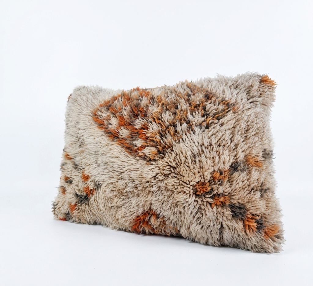 Handcrafted Moroccan-style shag lumbar pillow cover featuring a textured cream base with rust orange and brown geometric diamond motifs, isolated on a white background.