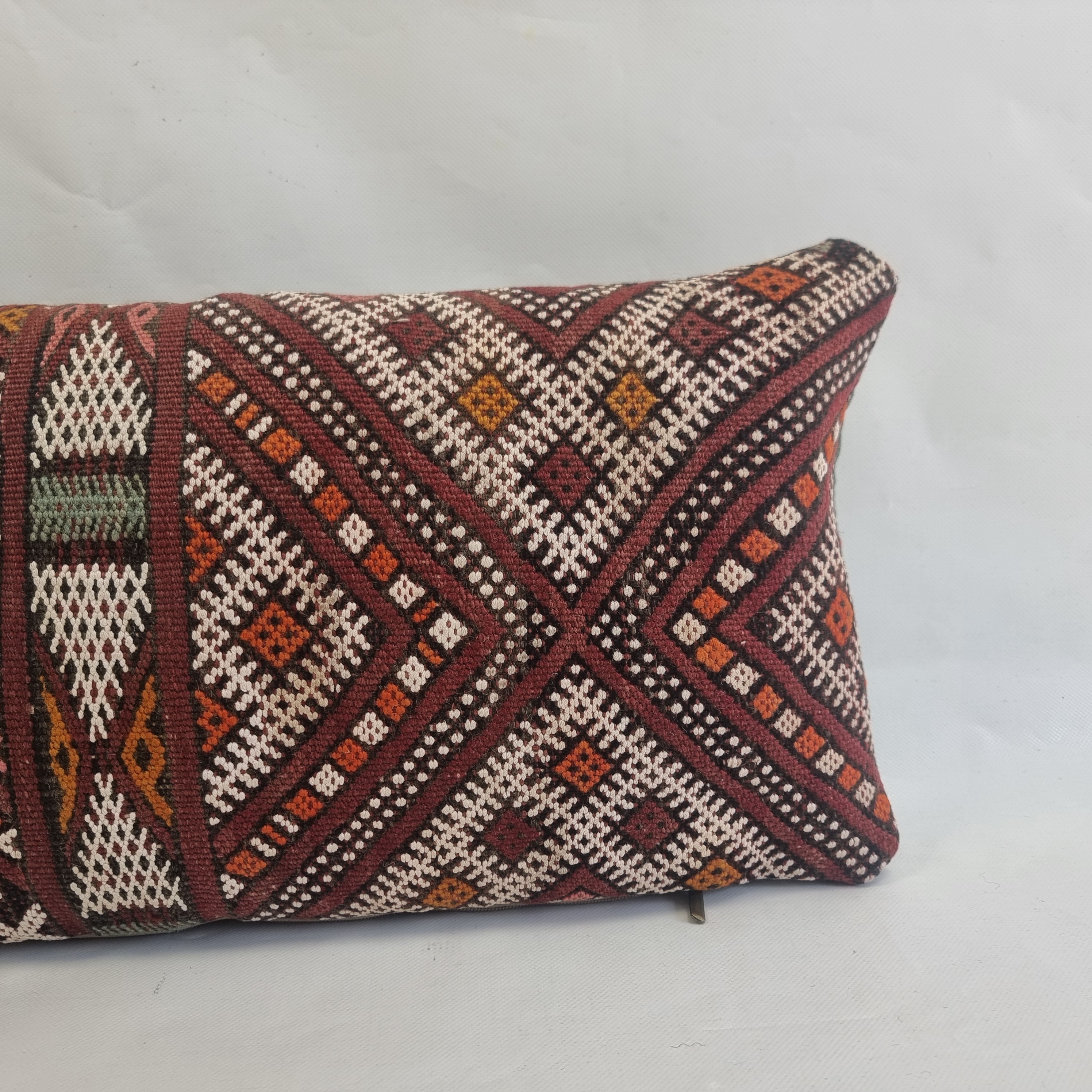 Decorative pillow with geometric pattern on a white background