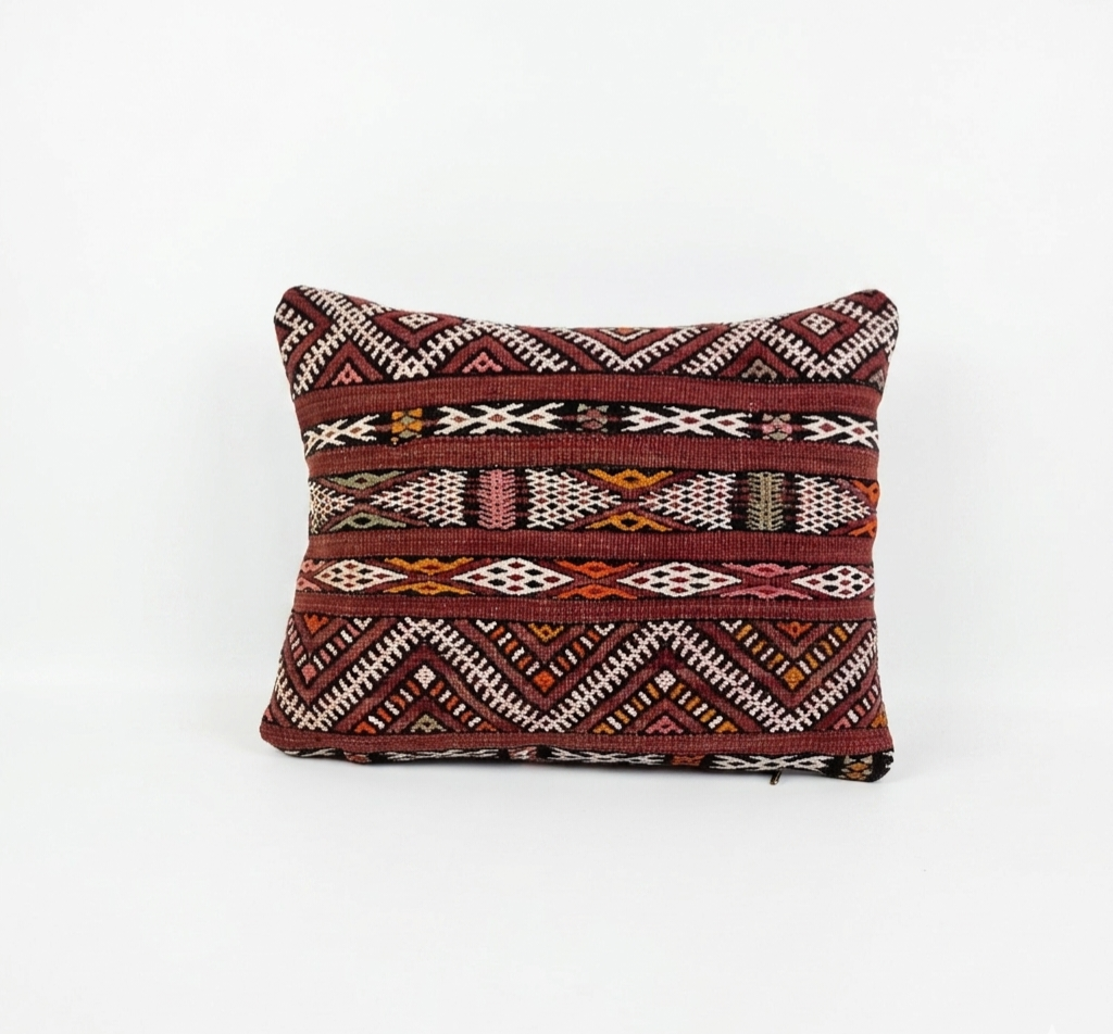 Decorative pillow with tribal pattern on a white background